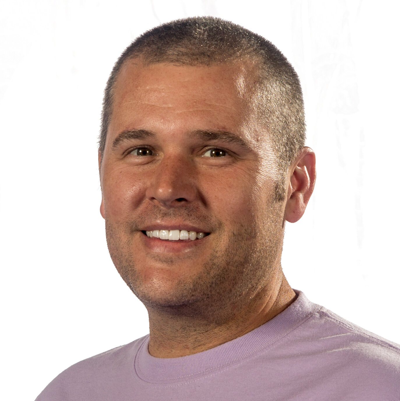 headshot of smiling man in t-shirt with closely cropped hair